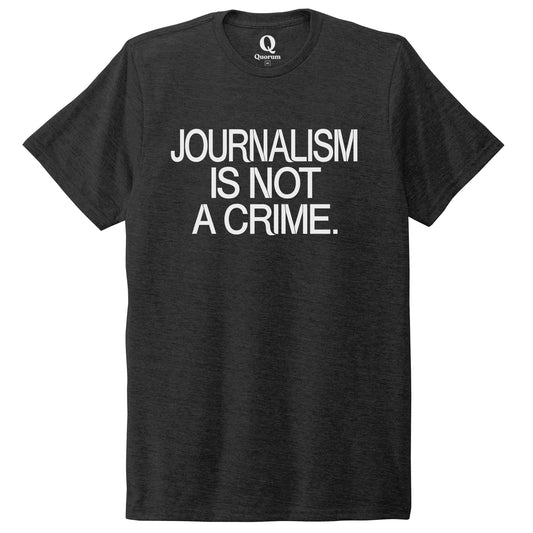 "Journalism is not a crime." Quorum Unisex Tri-Blend Tee editorial print in Space Black