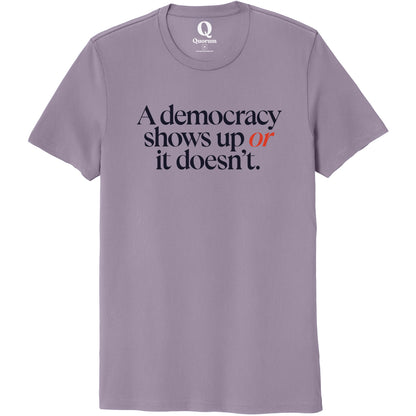 "A democracy shows up or it doesn't." Quorum Unisex 100% Organic Cotton Tee front print in Cosmic Purple