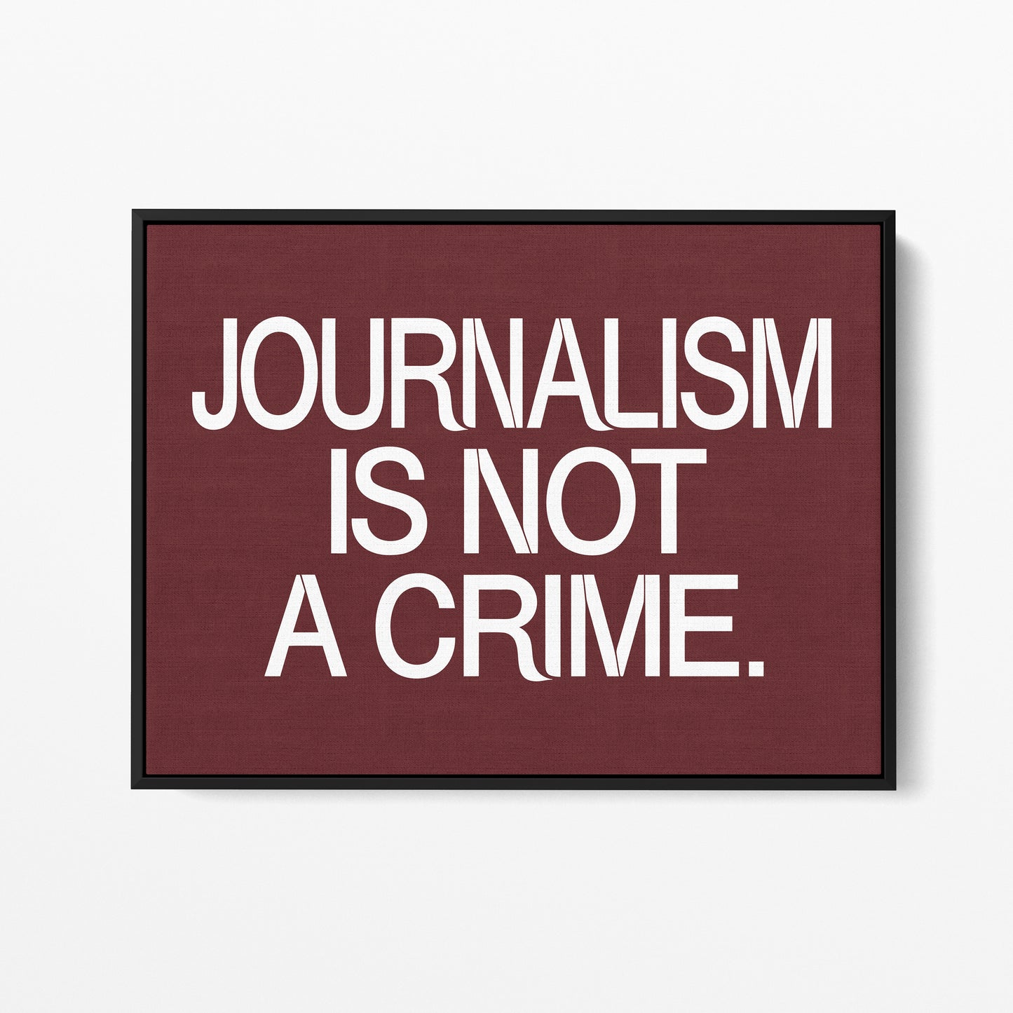 Journalism Is Not a Crime — Quorum framed gallery canvas in black hardwood floater frame, landscape orientation